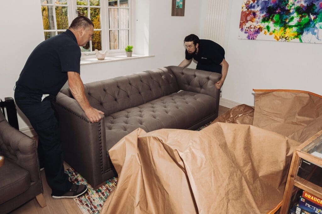 men carrying a sofa
